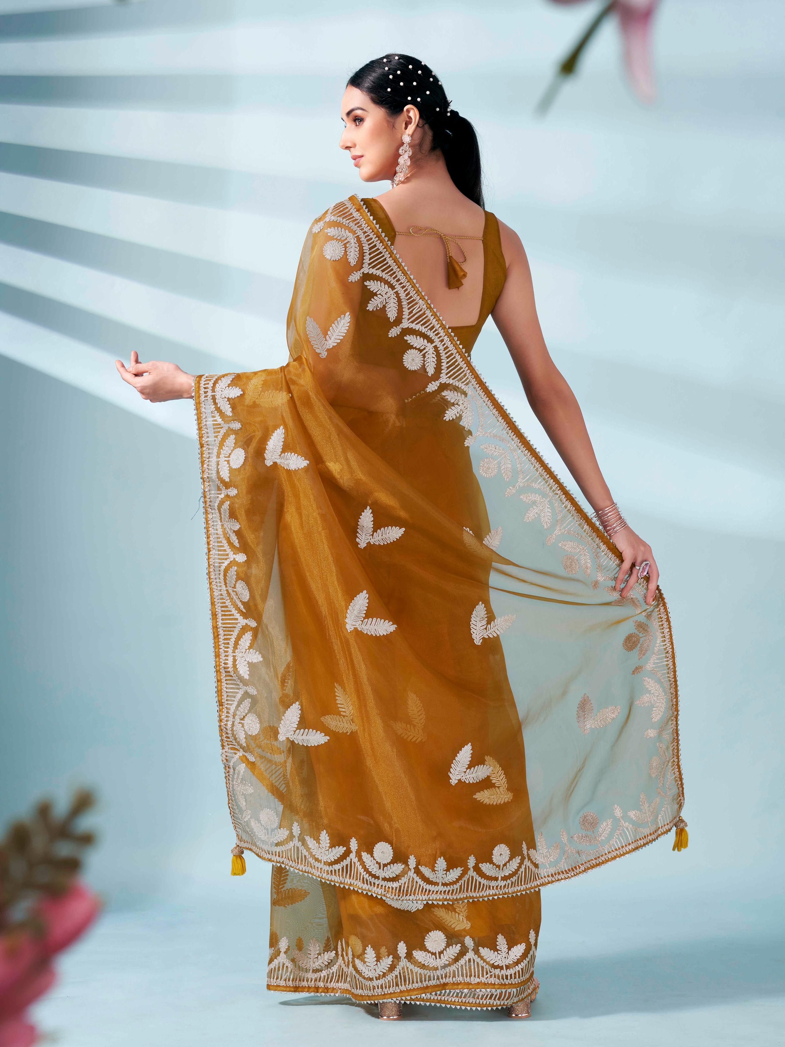 Mustard colored organza saree with gota patti embroidery and embellished border