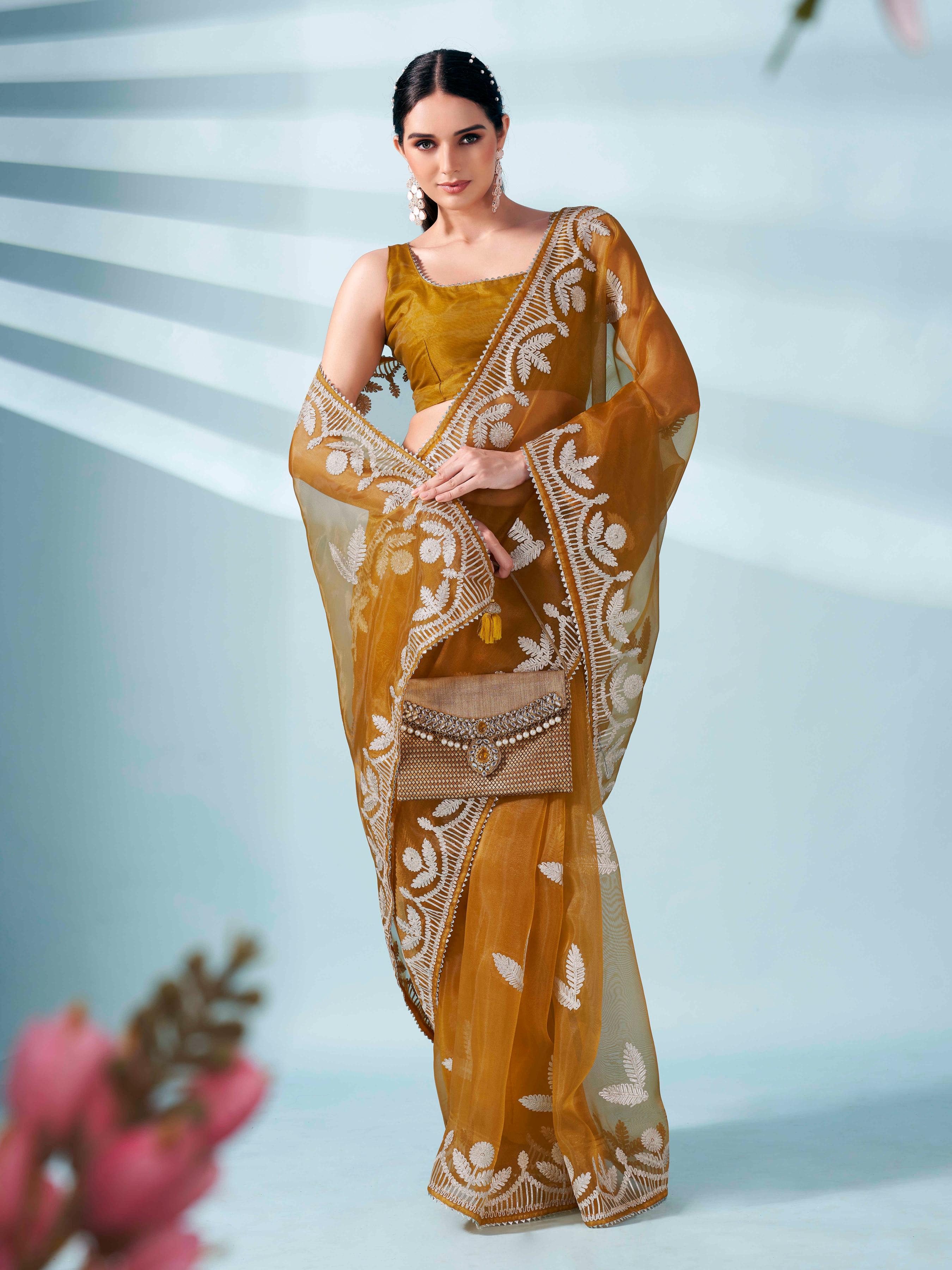 Mustard colored organza saree with gota patti embroidery and embellished border