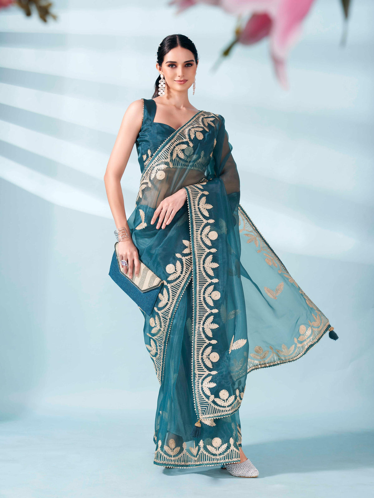 Sea green colored organza saree with gota patti embroidery and embellished border