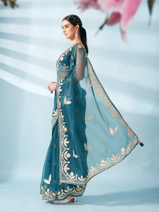 Sea green colored organza saree with gota patti embroidery and embellished border