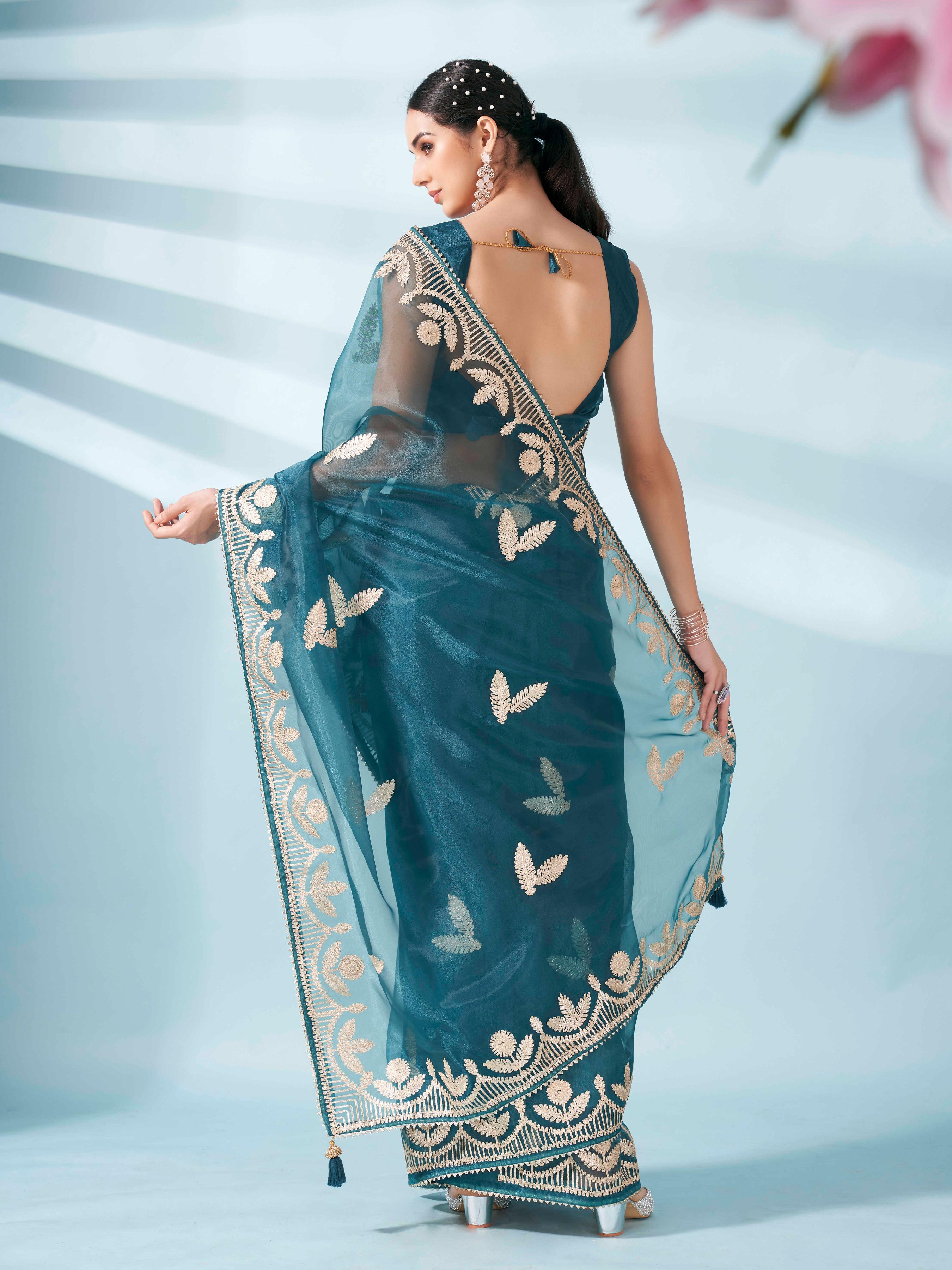 Sea green colored organza saree with gota patti embroidery and embellished border