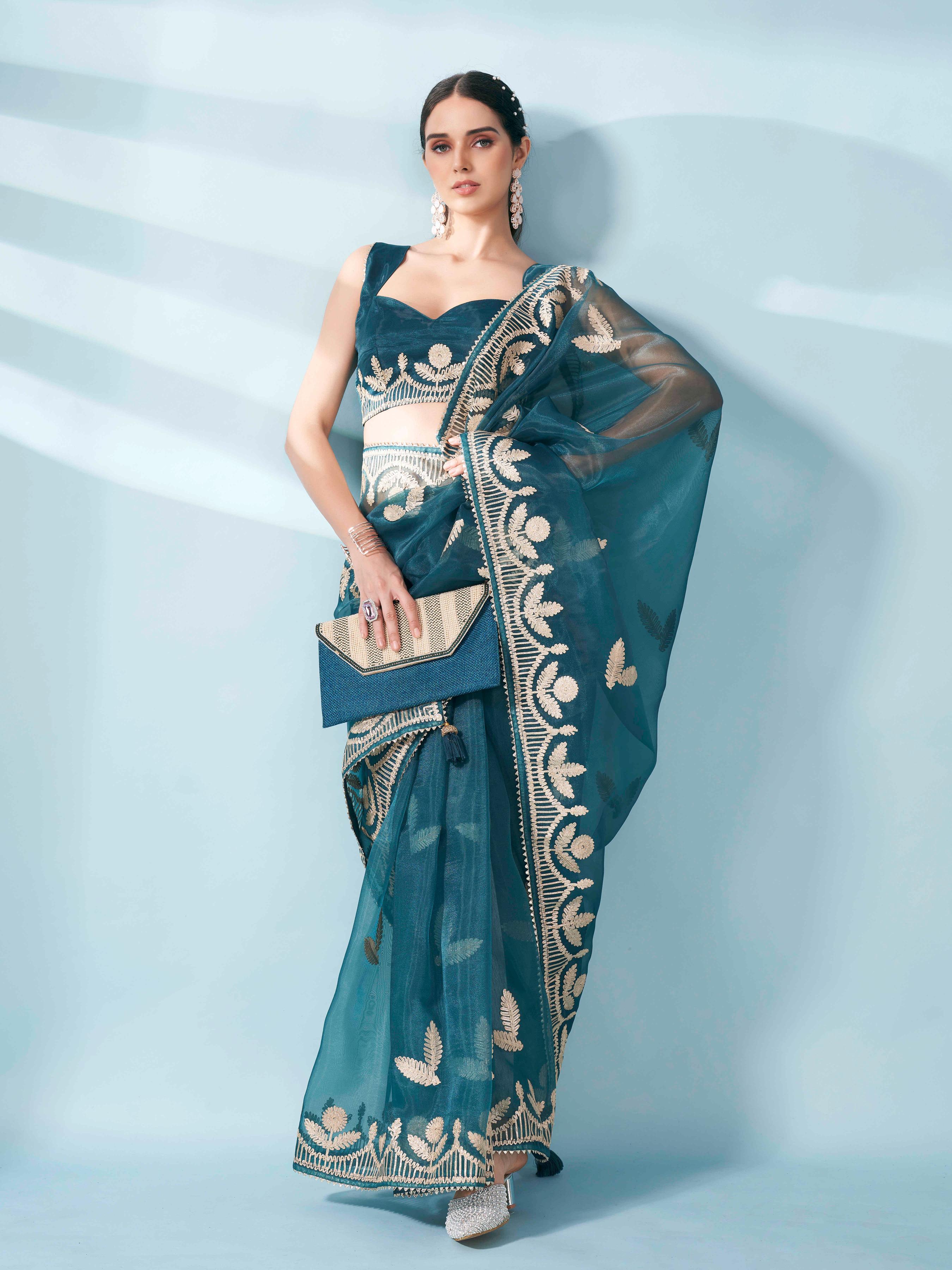 Sea green colored organza saree with gota patti embroidery and embellished border