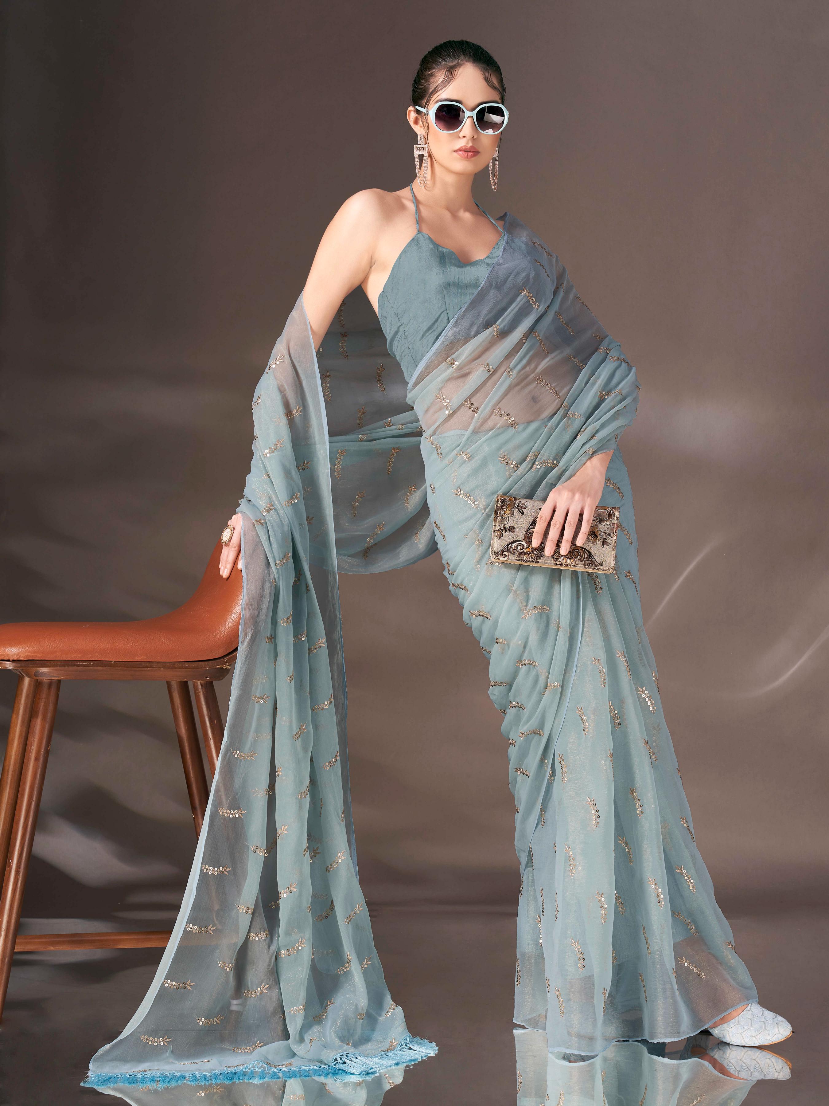 Blue colored sequin embroidered shimmer chiffon saree with tassles on pallu