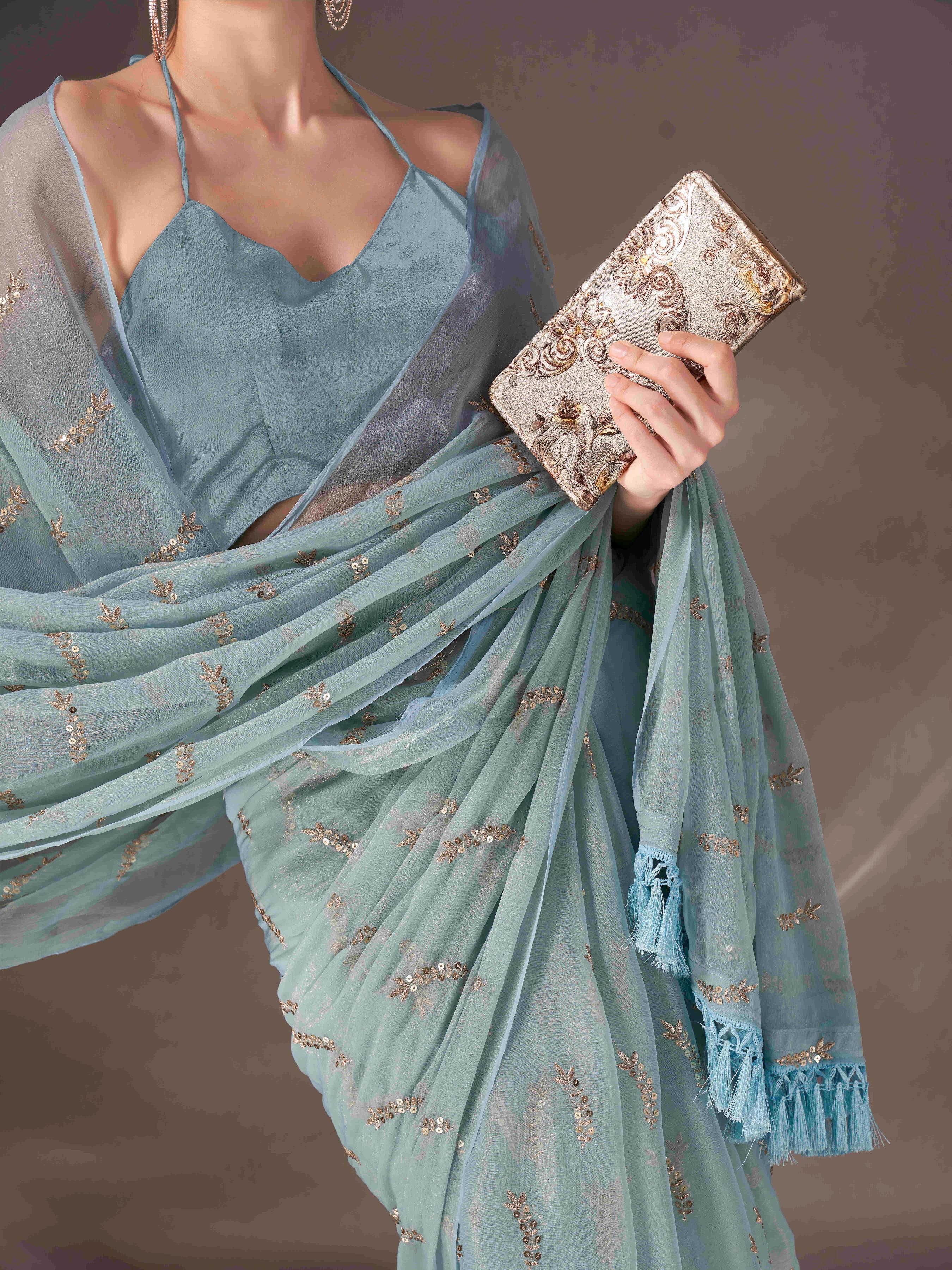 Blue colored sequin embroidered shimmer chiffon saree with tassles on pallu