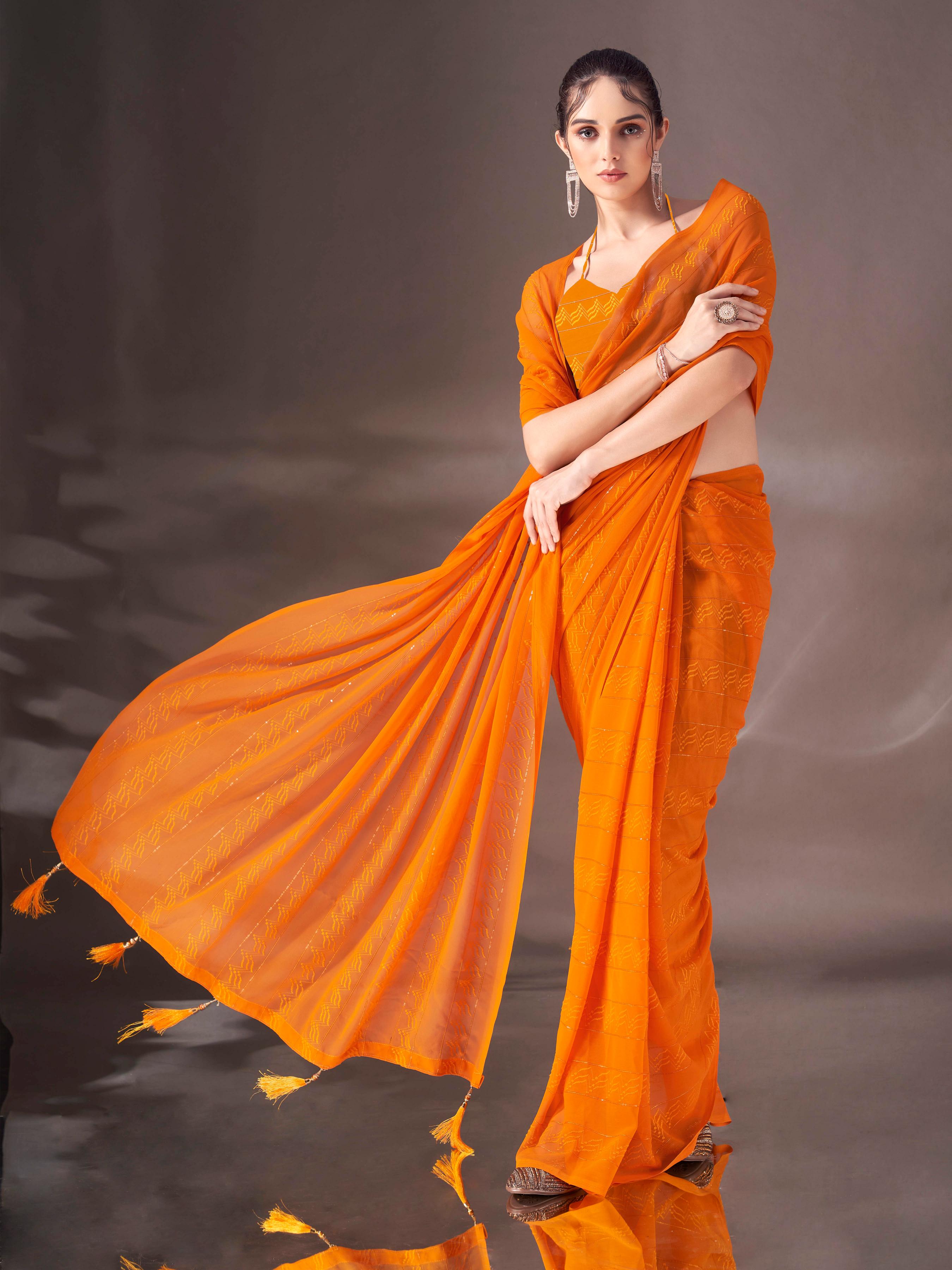 Mustard colored striped saree with tassles on pallu