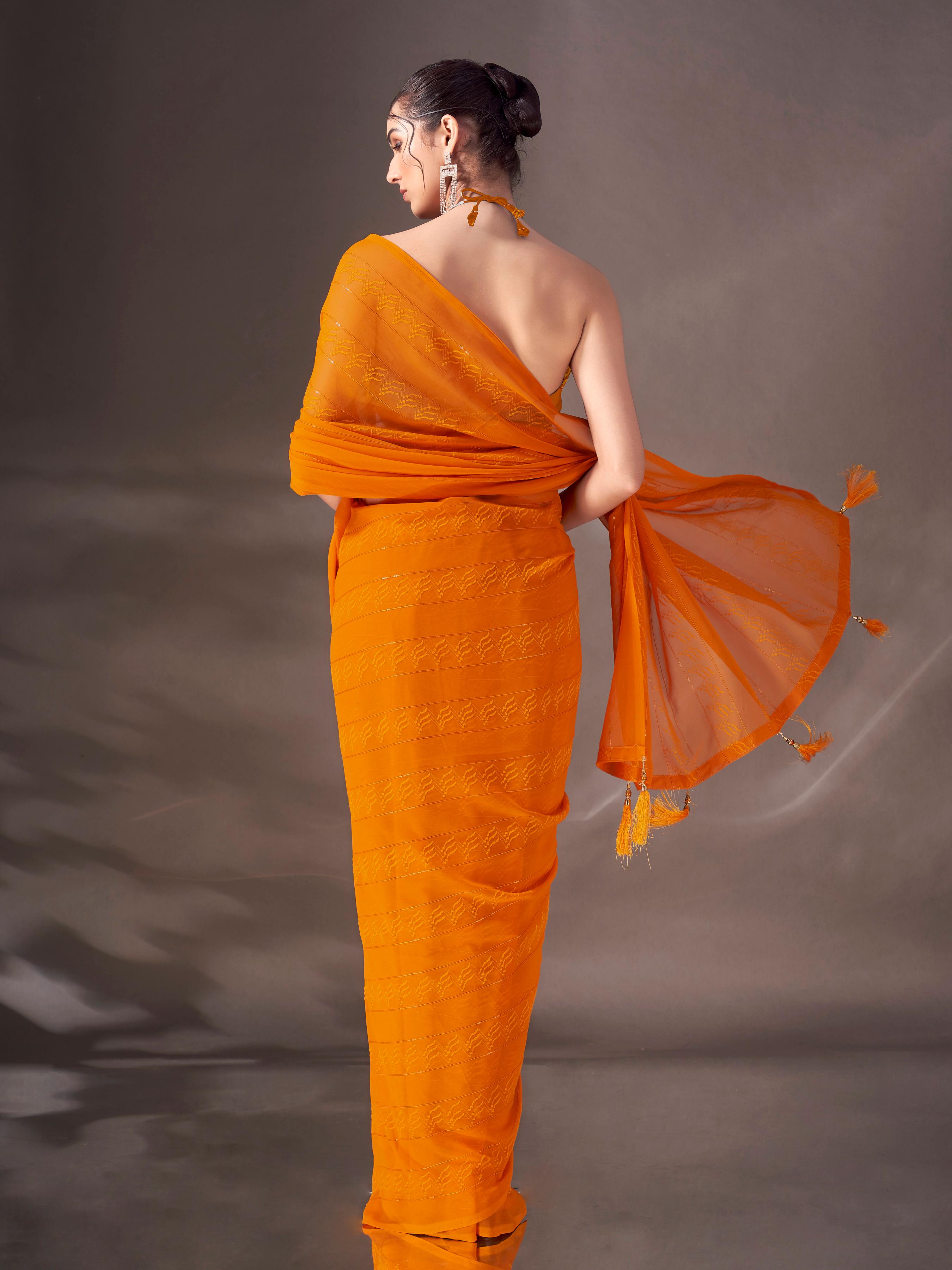 Mustard colored striped saree with tassles on pallu