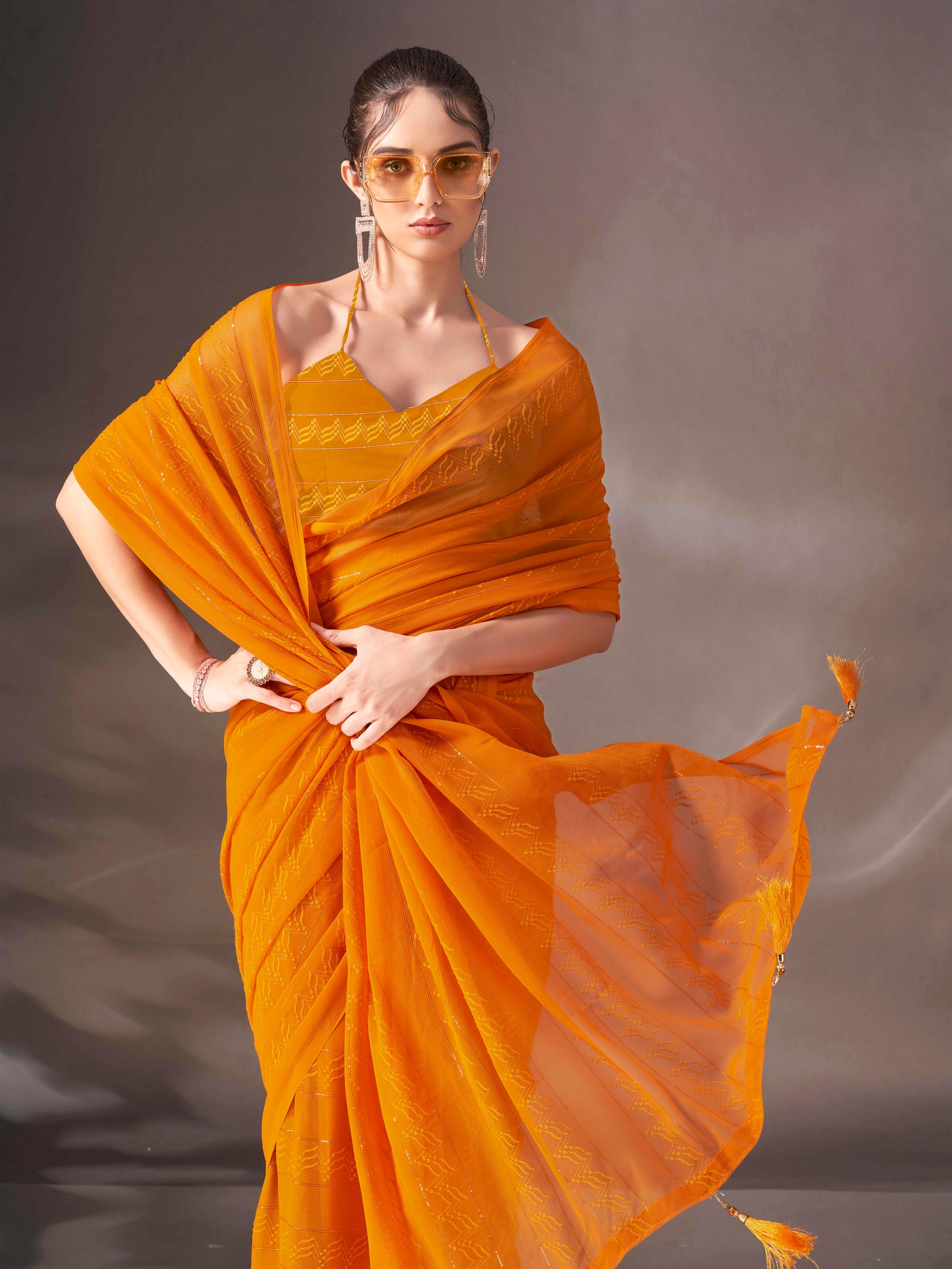 Mustard colored striped saree with tassles on pallu