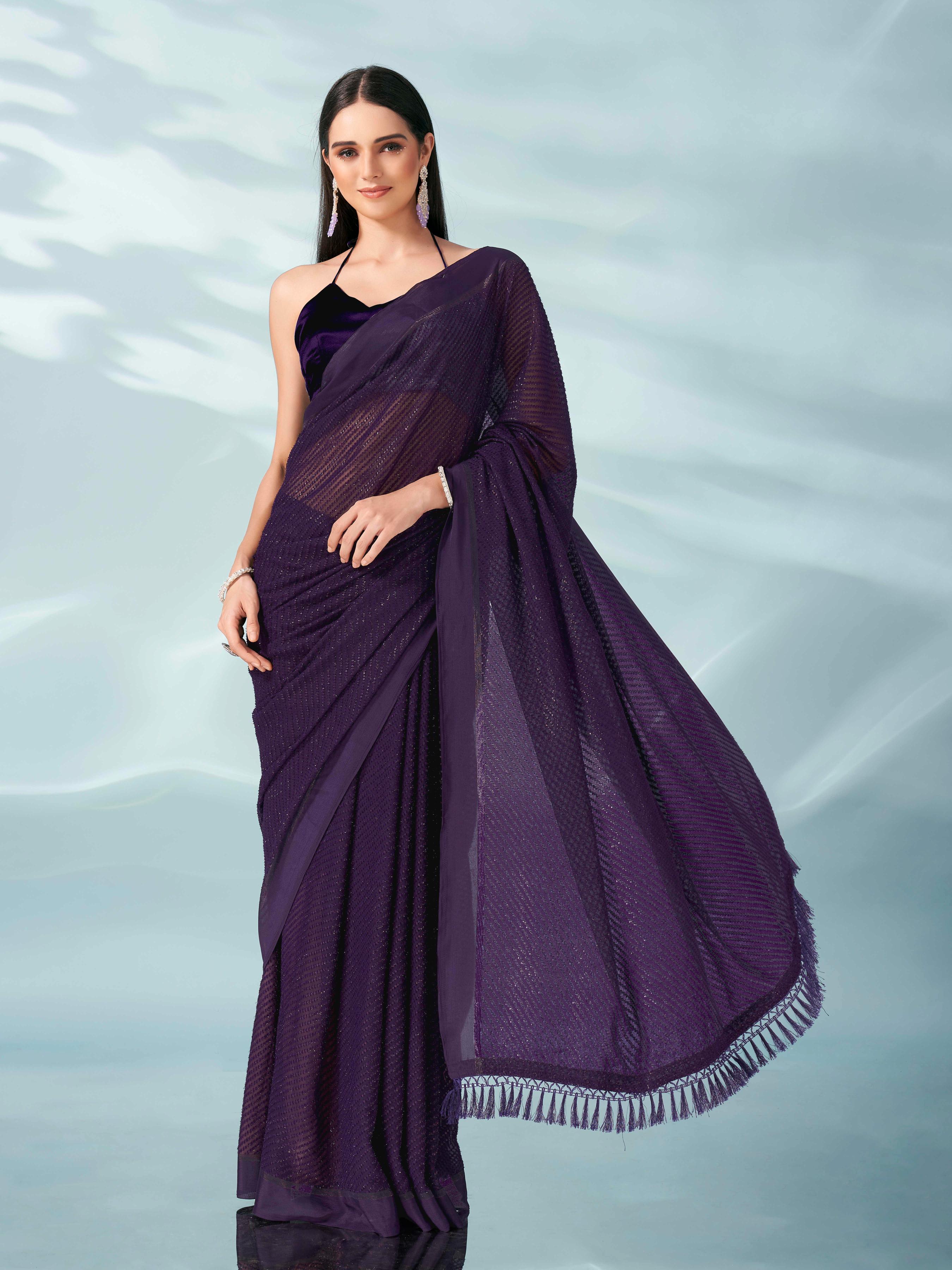 Purple colored lurex zari butti and satin border saree with tassles on palliu