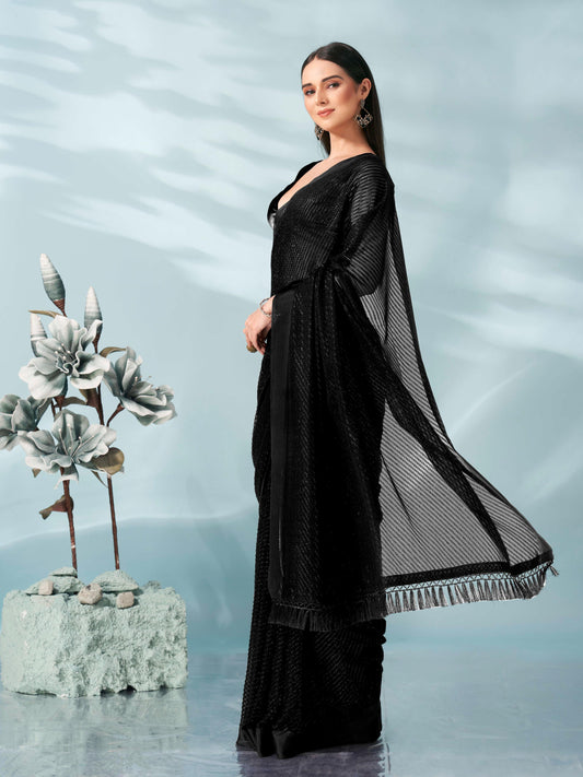 Black colored lurex zari butti and satin border saree with tassles on palliu