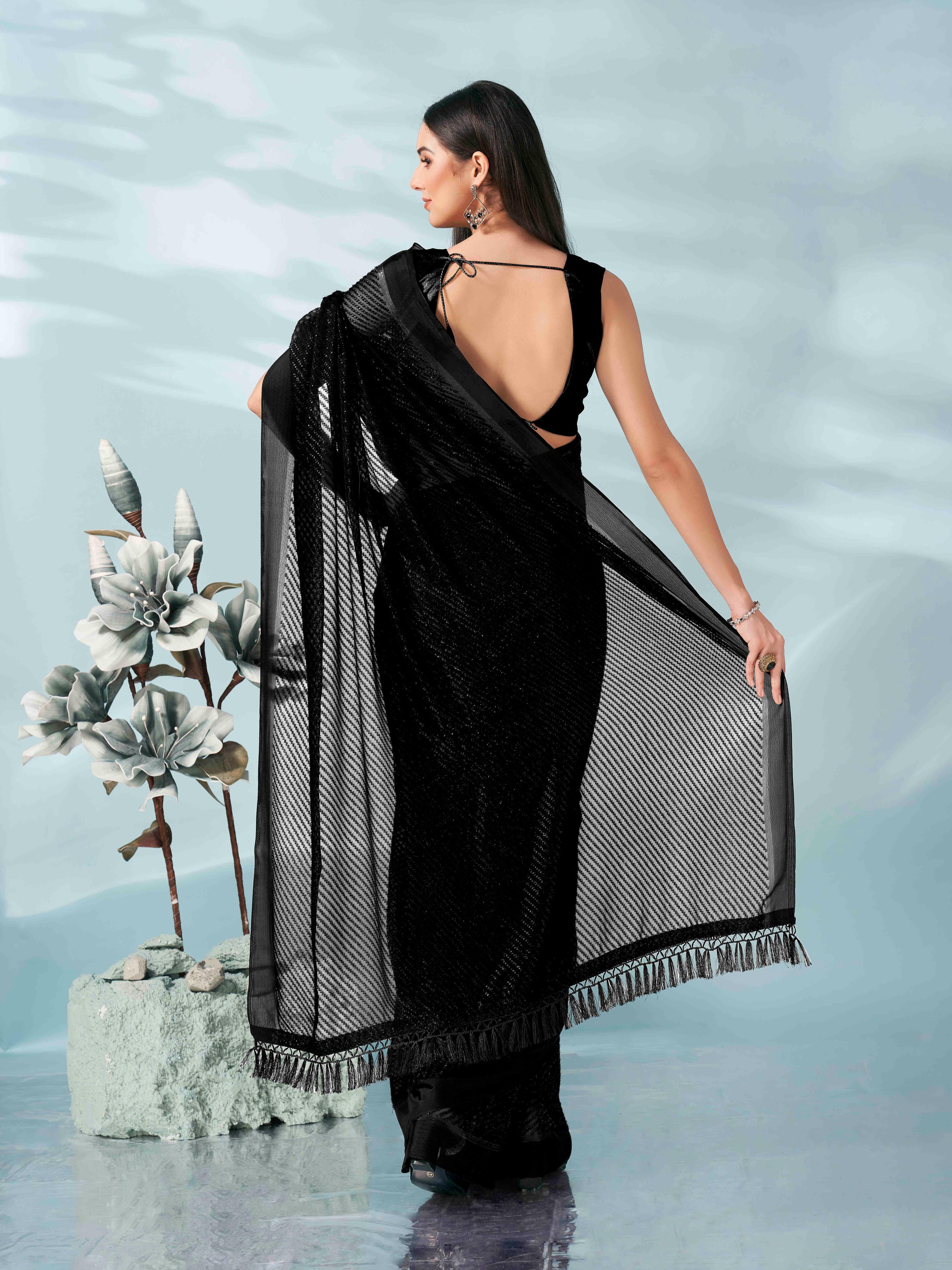 Black colored lurex zari butti and satin border saree with tassles on palliu