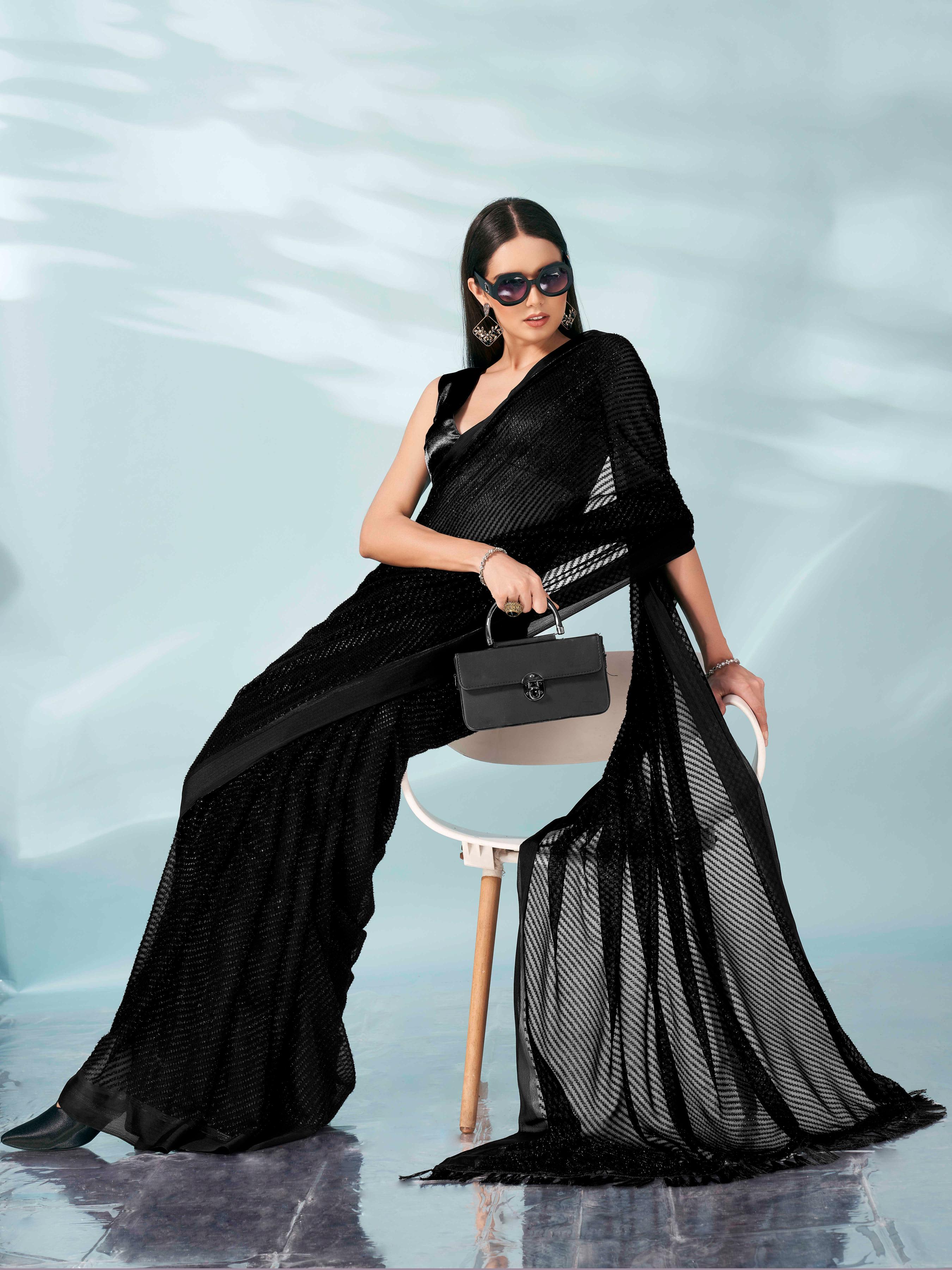 Black colored lurex zari butti and satin border saree with tassles on palliu