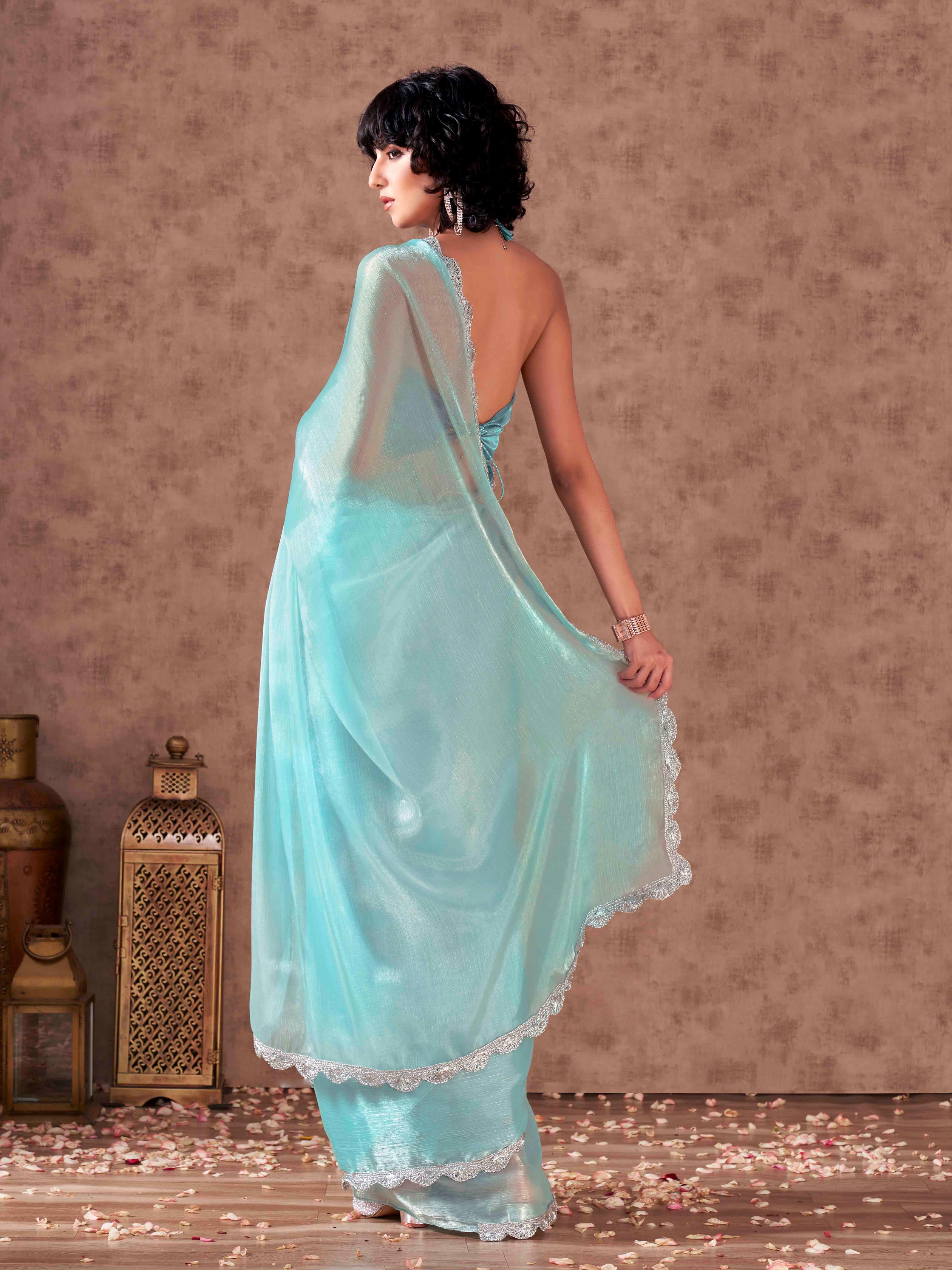 Blue colored shimmer chiffon saree with embellished lace and blouse