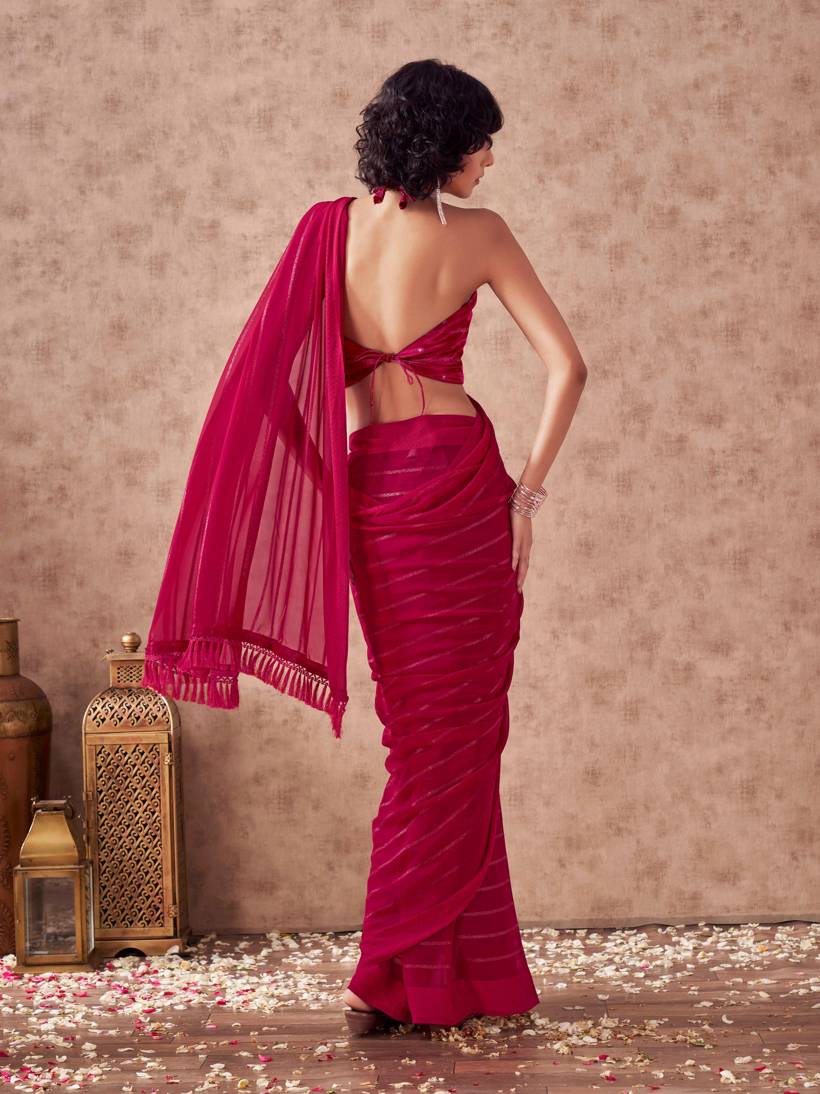 Maroon colored striped saree with embroidered blouse