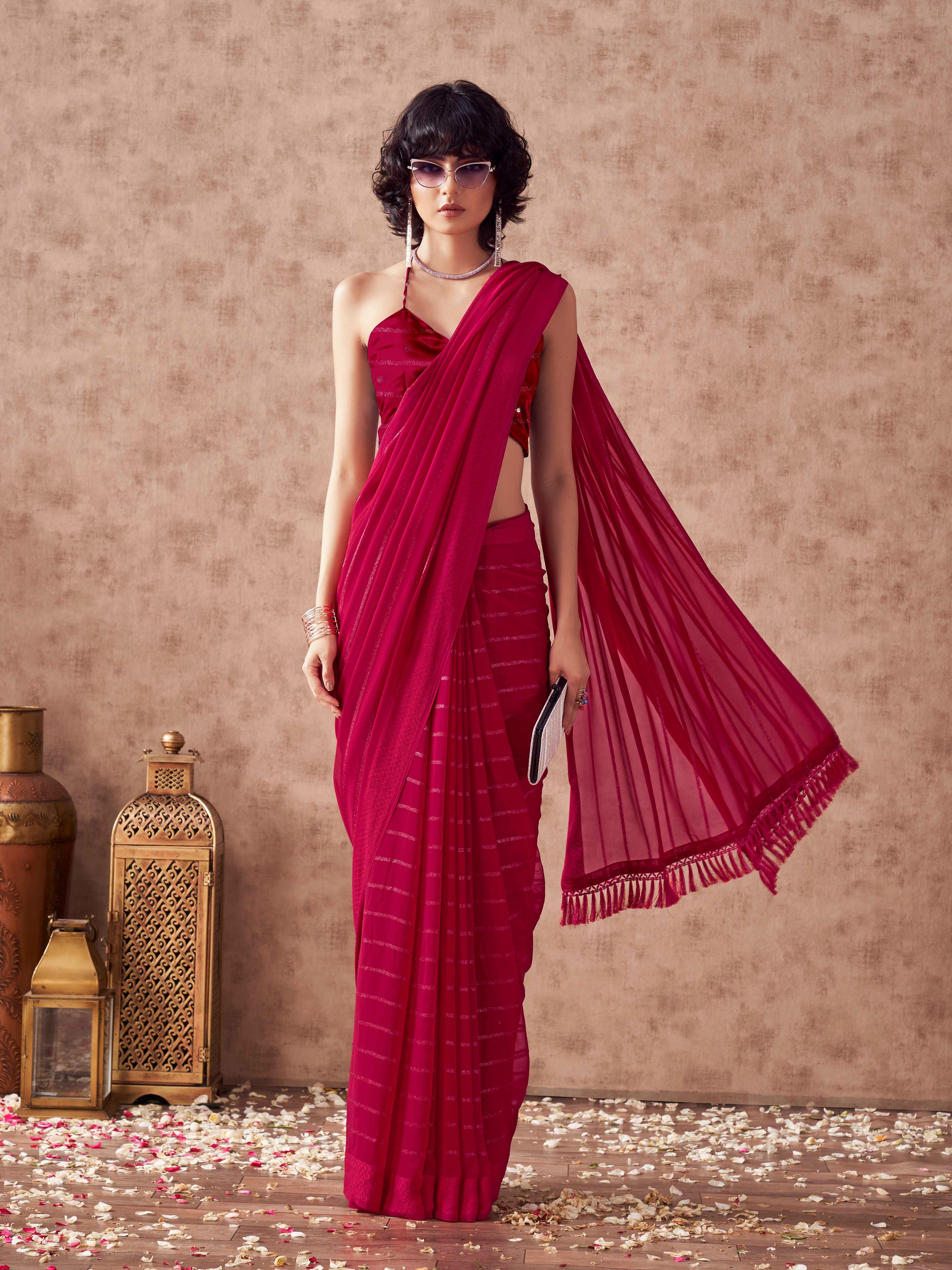 Maroon colored striped saree with embroidered blouse