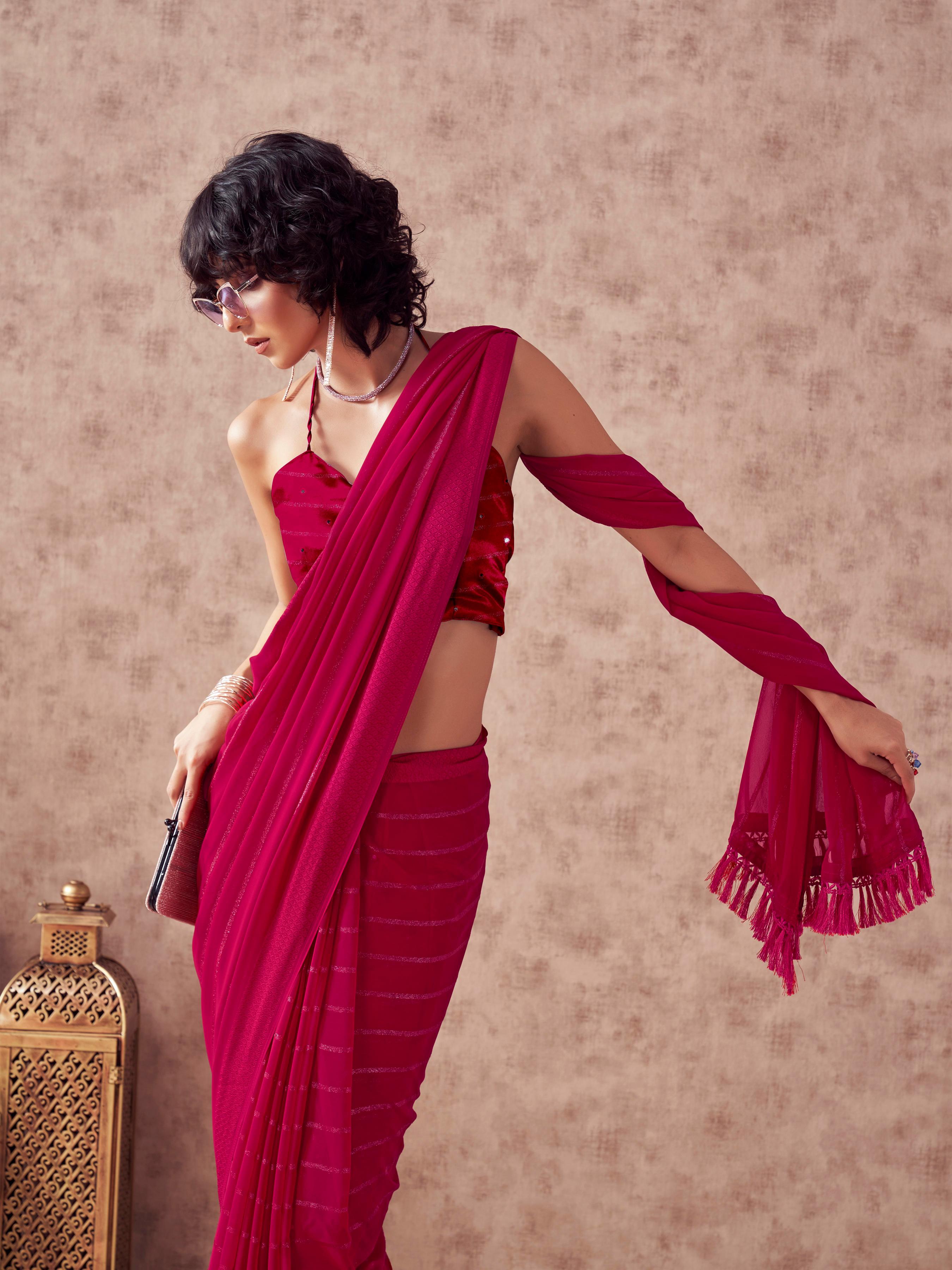 Maroon colored striped saree with embroidered blouse