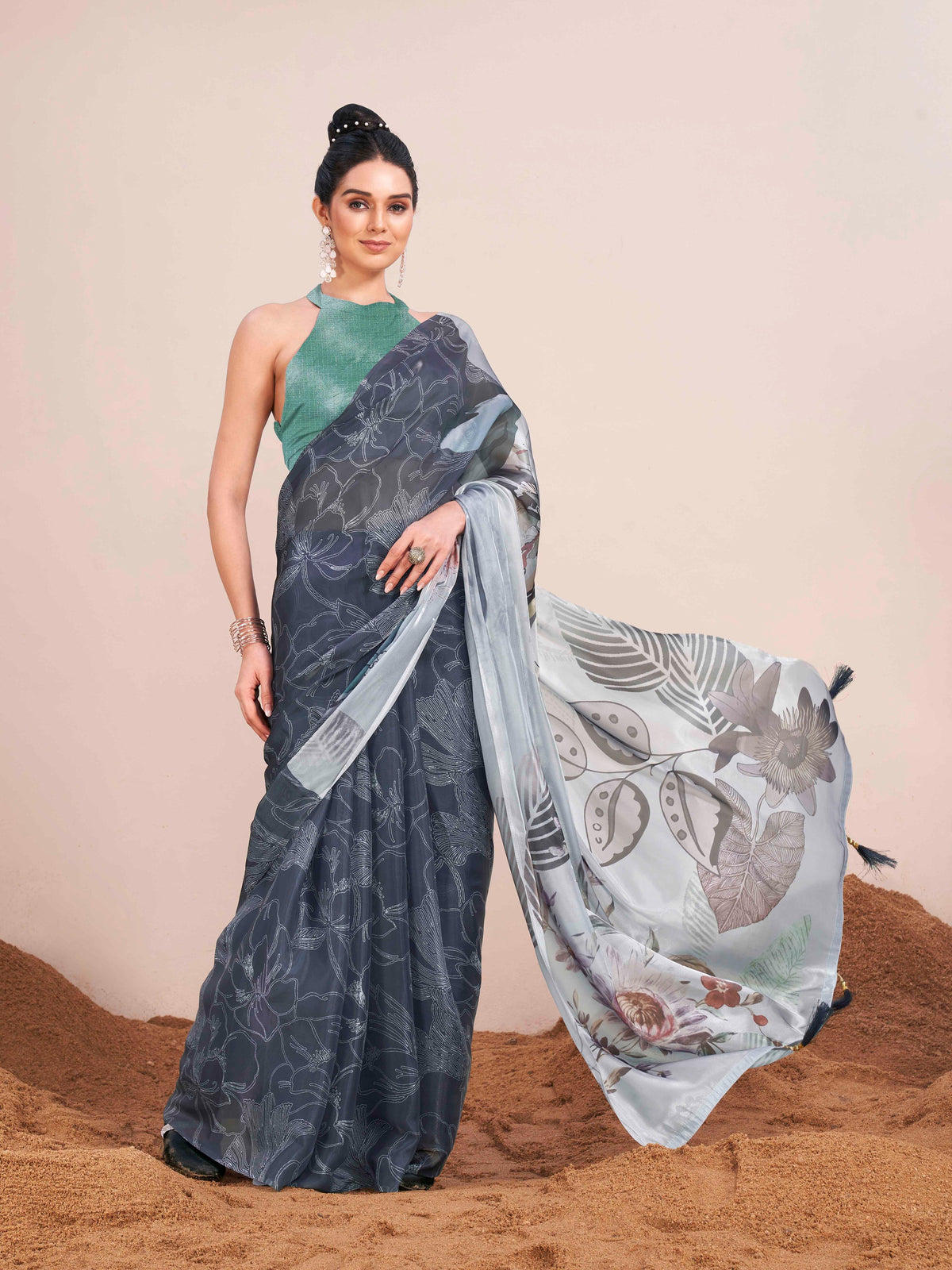 Metallic blue colored digital printed shimmer chiffon saree with tassles on pallu