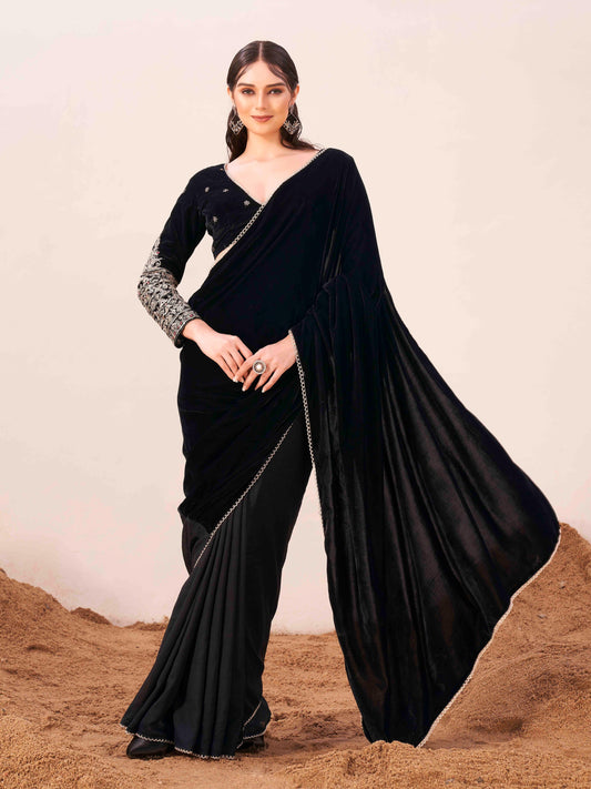 Black colored velvet half and half saree with heavy embroidered full sleeves blouse