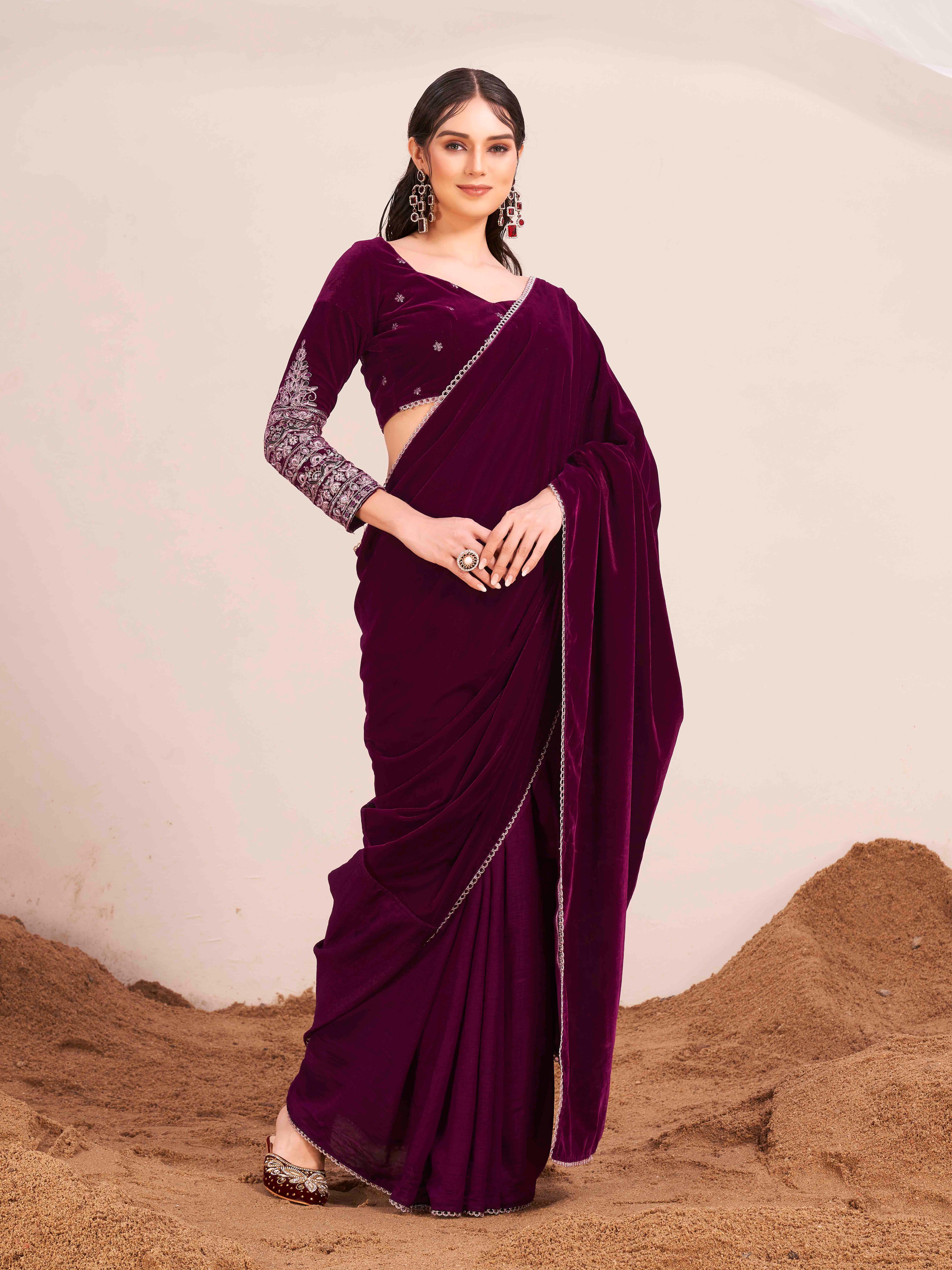 Magenta colored velvet half and half saree with heavy embroidered full sleeves blouse