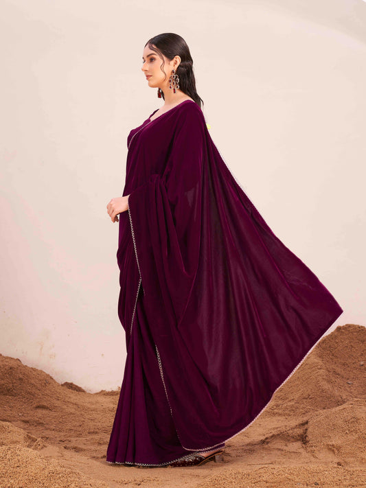 Magenta colored velvet half and half saree with heavy embroidered full sleeves blouse