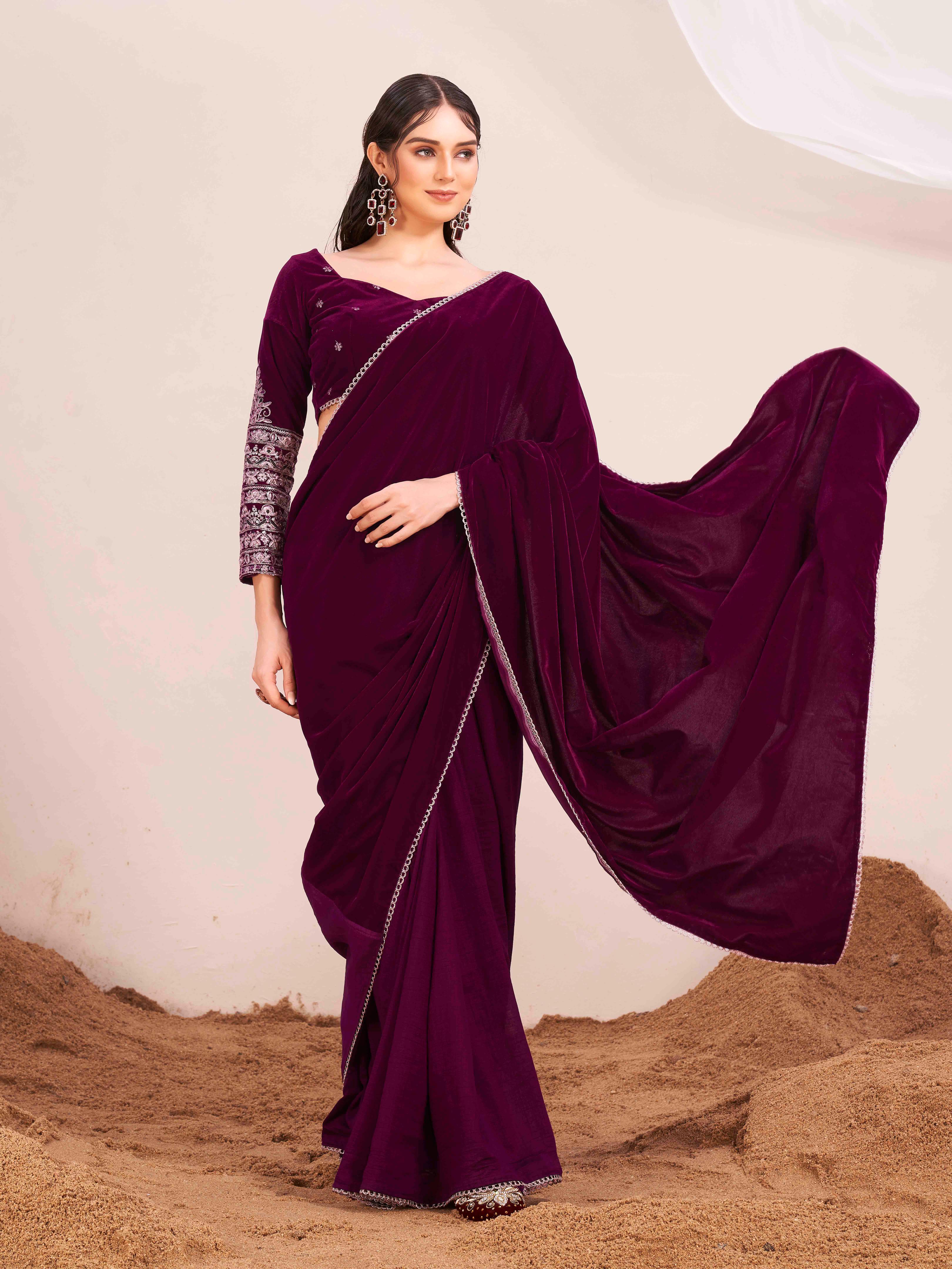 Magenta colored velvet half and half saree with heavy embroidered full sleeves blouse