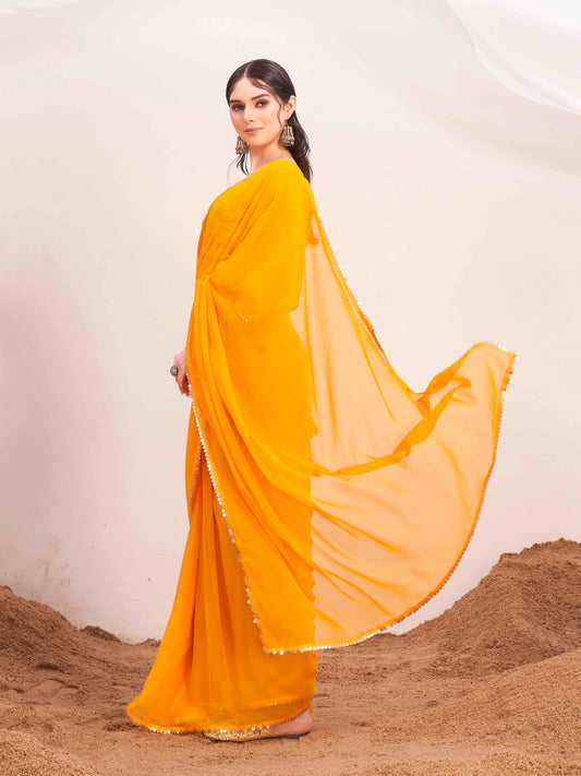 Yellow colored poly georgette saree with embroidered blouse and belt