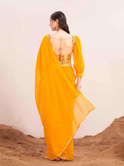 Yellow colored poly georgette saree with embroidered blouse and belt