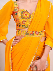 Yellow colored poly georgette saree with embroidered blouse and belt