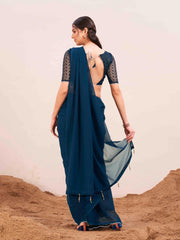 Blue colored designer poly georgette saree with embroidered blouse and a metallic ring on waist to accentuate the pallu