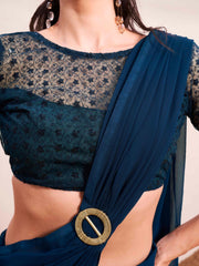 Blue colored designer poly georgette saree with embroidered blouse and a metallic ring on waist to accentuate the pallu