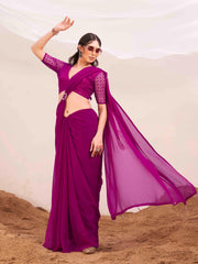 Pink colored designer poly georgette saree with embroidered blouse and a metallic ring on waist to accentuate the pallu