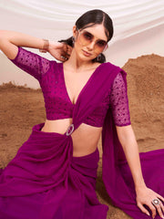 Pink colored designer poly georgette saree with embroidered blouse and a metallic ring on waist to accentuate the pallu