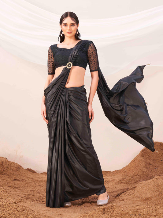 Metallic Charcoal black colored designer satin saree with embroidered blouse and metallic ring on waist to accentuate the pallu