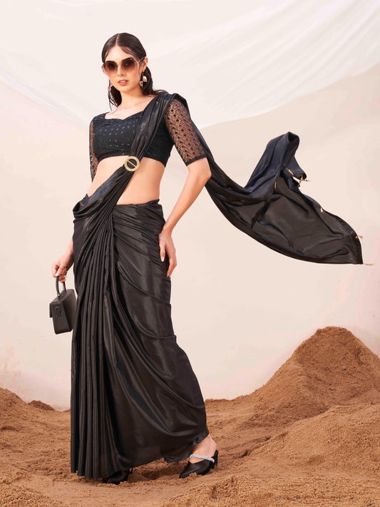 Metallic Charcoal black colored designer satin saree with embroidered blouse and metallic ring on waist to accentuate the pallu