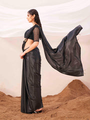 Metallic Charcoal black colored designer satin saree with embroidered blouse and metallic ring on waist to accentuate the pallu