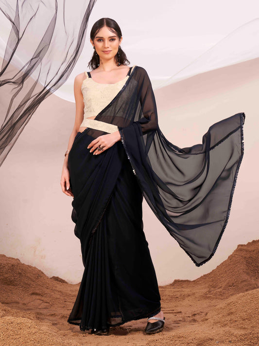 Black colored poly georgette saree with embroidered blouse and belt