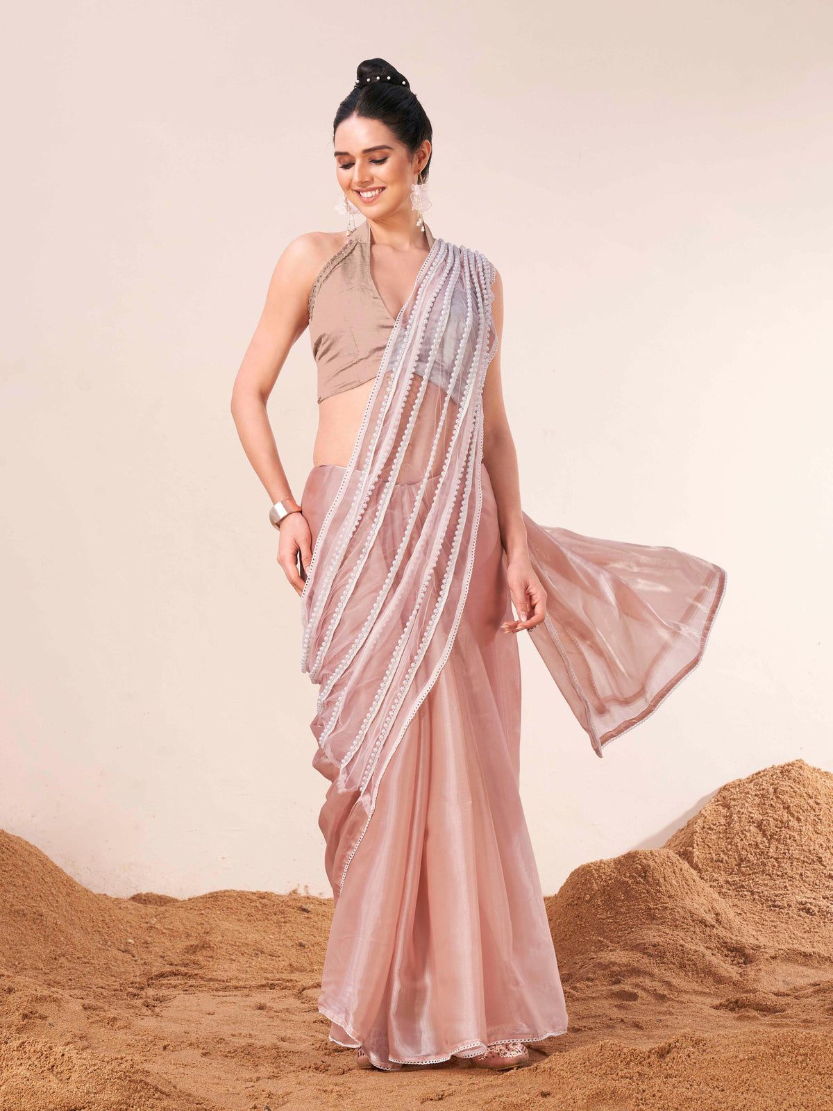 Peach colored fancy designer saree with moti lace on shoulder portion