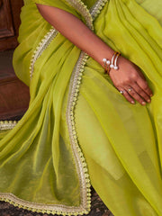 Green colored shimmer chiffon saree with embellished lace and brocade blouse