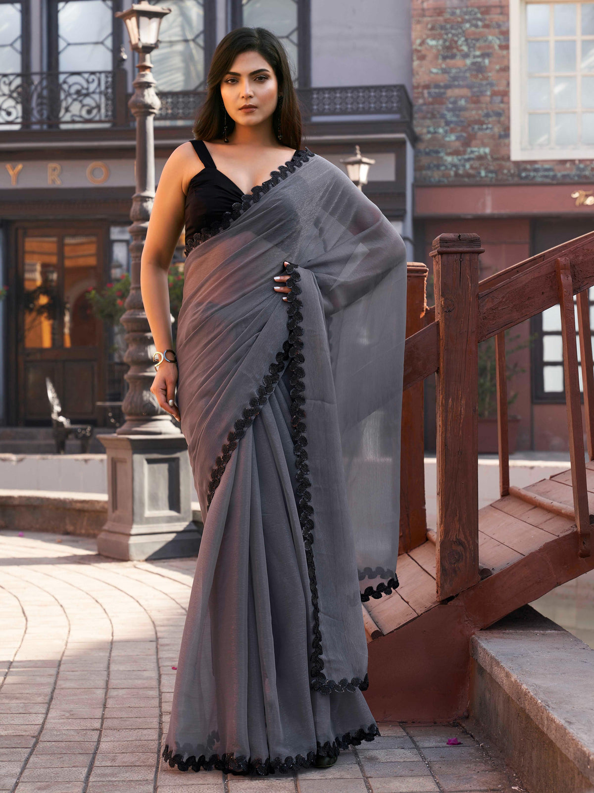 Grey colored shimmer chffon saree with cutwork border