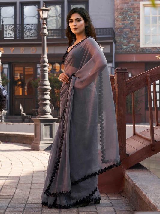 Grey colored shimmer chffon saree with cutwork border