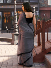 Grey colored shimmer chffon saree with cutwork border