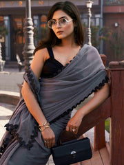 Grey colored shimmer chffon saree with cutwork border