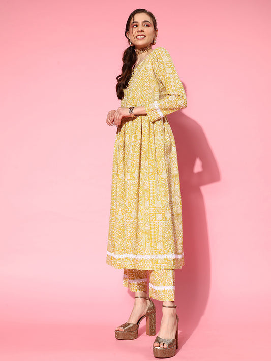 Women Mustard Printeda-Line Kurta With Front Slit,  Embellished With Fabric Potli Button In Placket, Paired With Tonal Printed Bottom