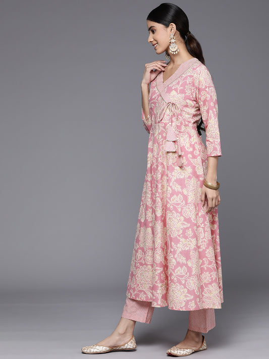 Women pink floral printed angrakha style anarkali kurta paired with printed bottom.