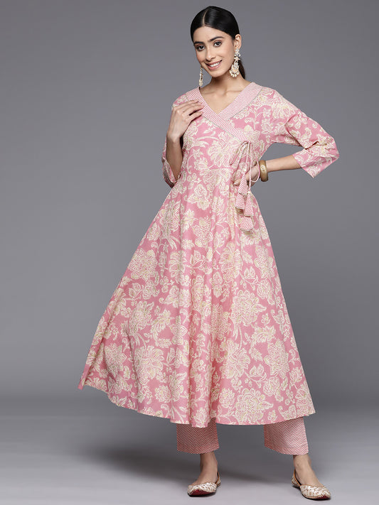 Women pink floral printed angrakha style anarkali kurta paired with printed bottom.